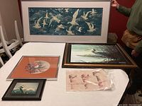 Full lot display showing 5 pieces of bird-themed wall art on a table with person holding one print.