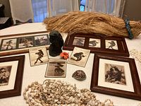 Group shot showing framed prints, loose prints, coral bust, grass skirt, top, shell accessories