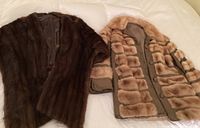 Dark brown mink stole and vintage leather mink car coat laid flat on bed