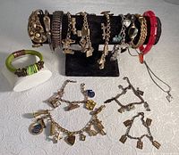 Full display of bracelets on stand plus two separate bracelets and one necklace