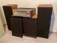 Wide shot of receiver and four speakers grouped against wall
