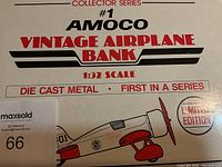 Photo of the box front showing collector series number, AMOCO branding, and vintage airplane bank in 1:32 scale.