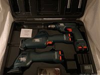Black & Decker tool kit in black molded plastic case showing tools and batteries in place.