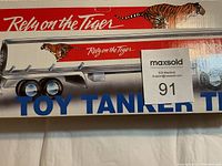 Close-up of the left side of the box showing the EXXON toy tanker truck graphics with tiger and 'Rely on the Tiger' text.