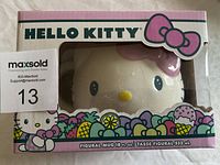 Photo showing the front of the unopened Hello Kitty figural mug box with branding and colorful decorative elements.