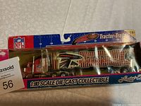 Front view of the die-cast tractor-trailer still in original NFL branded packaging showing the Atlanta Falcons logos and colors.