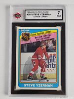 Front view of the graded 1984-85 O-Pee-Chee Steve Yzerman Rookie NHL Scoring Leader hockey card in protective slab with grading label showing grade 7 Near Mint