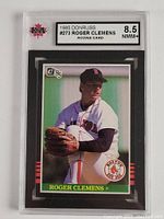 Photo of the front of the 1985 Donruss #273 Roger Clemens rookie baseball card in graded slab, showing player's pitching pose and grade label.