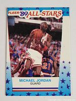 Front of 1989 Fleer All-Stars Michael Jordan basketball card showing Jordan in Chicago Bulls uniform mid-action with blue starry border and card details.