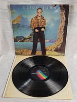 Photo showing LP vinyl disc, inner sleeve, and front cover standing upright. Covers and disc visible in good overall condition.