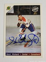 Front of signed Henri Richard hockey card showing player photo and autograph in blue ink.