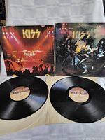 Two vinyl records and two cover sleeves displayed side by side showing front of records with labels and cover artwork