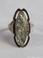 Front view of sterling silver ring with elongated oval abalone shell with varved pattern