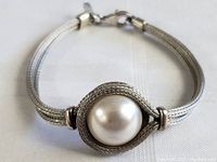 Front view of sterling silver art deco bracelet showing woven mesh band and large faux pearl centerpiece