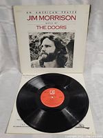 Front view of the album cover with the vinyl record and inner sleeve.