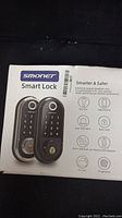 Front of Smonet Smart Lock box showing branding and feature icons