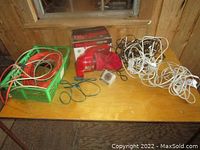 Full lot overview showing all items: handheld vacuum, extension cords in basket, white cords, timer.