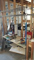 Front view of ShelfTech NSF metal wire storage rack with adjustable shelves, showing scratches and used condition.