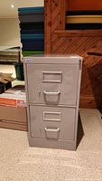 Front view of the metal file cabinet showing two drawers with label holders and chrome handles.