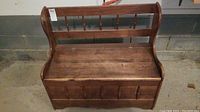 Front and side view of wooden hall bench showing hinged lid and spindle backrest.