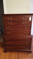Full front view showcasing the dresser's size, drawer arrangement and brass handles.