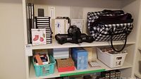 Shelf with Sizzix machine, die sets, binders, tote and storage bins