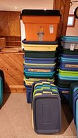 Two stacks of plastic storage bins showing total quantity and color variations