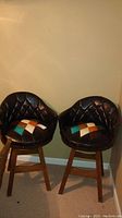 Two matching barrel-style bar stools side by side showing front view