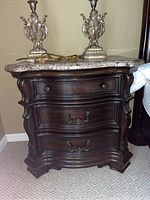 Front view of nightstand showing overall design, three drawers and marble top