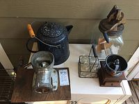 Close-up view of enamel pot and meat grinder handles and surfaces.