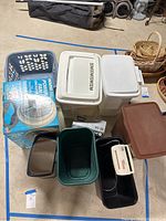 All items displayed including laundry baskets, trash cans, shredder, and boxed fan