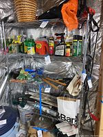 Front and side view of metal wire shelving unit in basement with items on shelves.