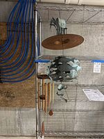 Photo showing the decorative metal wind chime with round disc and hanging metal pieces