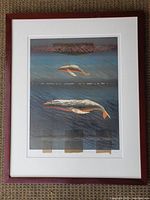 Front view of framed lithograph on floor, showing full artwork
