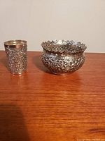 Side and angled view showing bowl and cup ornamentation and shapes