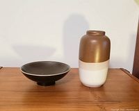 Side view of the pottery vase and bowl, showing vase color pattern and bowl shape.