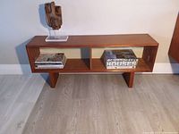 Front view showing two compartments, one open and one with sliding glass door, on block legs