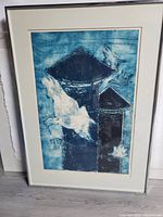Framed lithograph leaning against wall showing full composition