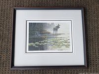 Full view of framed print showing moose at pond and frame
