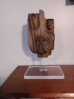 Front view of abstract wooden sculpture with acrylic base