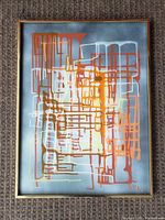 Full front view showing abstract grid design with multicolor drips on gray background and gold-tone frame