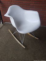 Front left angle view of white shell rocker showing overall shape