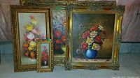 Group shot of four framed floral paintings