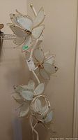 Full view of 73" tall white metal floor lamp with three flower-shaped etched glass shades