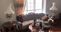 Two vintage style table lamps placed by a sofa and window, showing overall style and room setting.