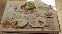 Box cover showing set contents and packaging with floral design of pots and pans.