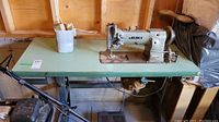 Left-side view of machine head, table, and floor motor assembly
