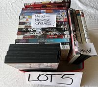Box with several anime DVDs including new unopened and some opened DVDs. Labeled to highlight condition.