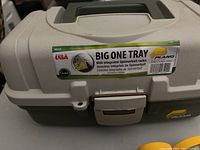 Closed view of beige and green Plano fishing tackle box with Big One Tray label.