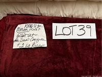 Photo of maroon velvet duvet cover with handwritten note indicating lot number and details about king size velvet set with duvet cover and 2 large pillows.